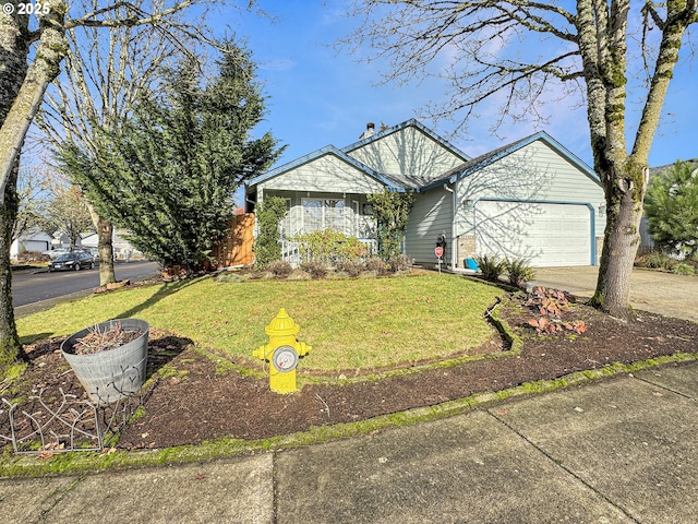 view of front of property featuring a front lawn and a garage