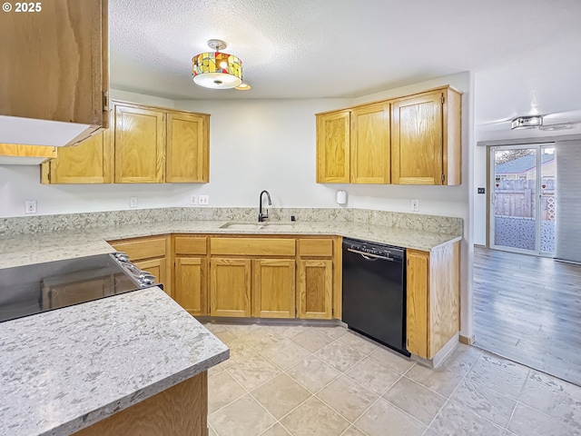 kitchen featuring sink, dishwasher, and a textured ceiling