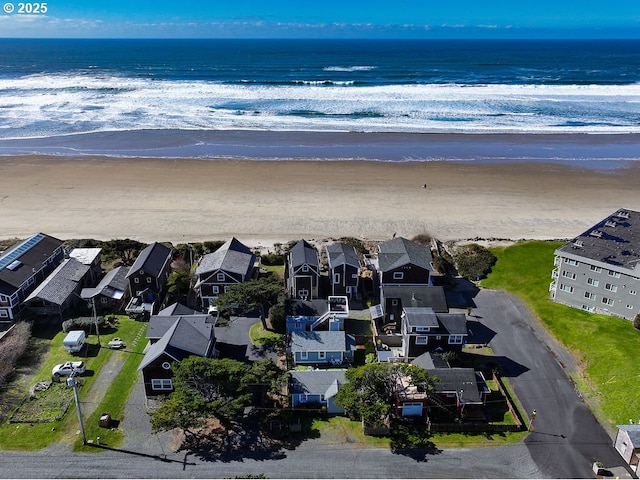 birds eye view of property featuring a residential view, a water view, and a beach view