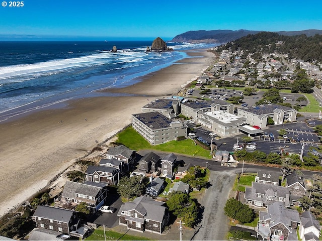 bird's eye view with a water view and a beach view