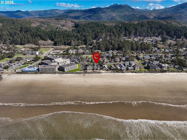 drone / aerial view featuring a forest view and a mountain view