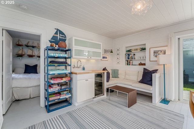 interior space with beverage cooler, wooden ceiling, and a sink