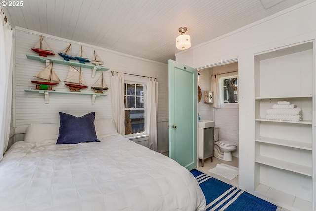 bedroom with connected bathroom and wood ceiling