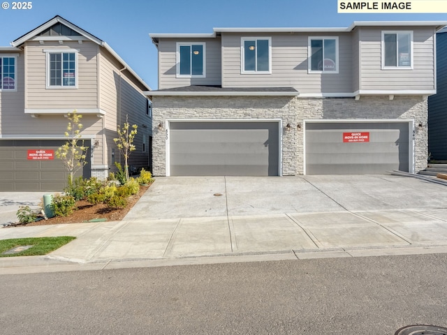 908 NW 178th Way, Ridgefield, WA 98642 - view of front of house with stone siding, concrete driveway, and an attached garage
