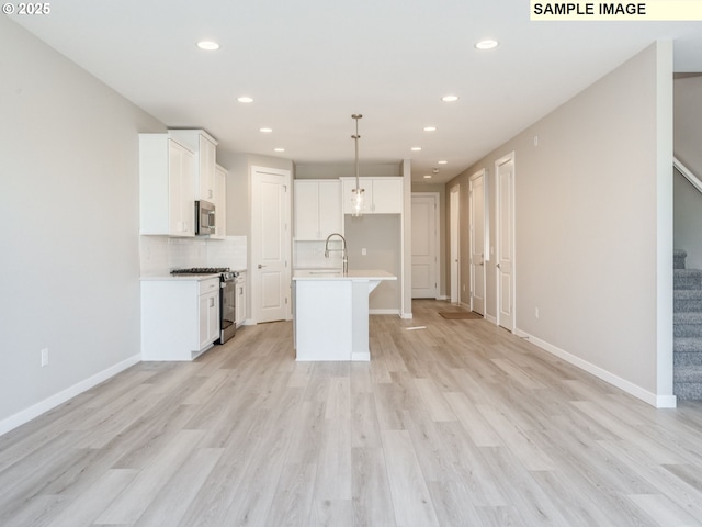 908 NW 178th Way, Ridgefield, WA 98642 - kitchen featuring stainless steel appliances, recessed lighting, open floor plan, decorative backsplash, and light countertops