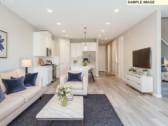 908 NW 178th Way, Ridgefield, WA 98642 - living area featuring recessed lighting, light wood finished floors, and baseboards