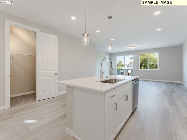908 NW 178th Way, Ridgefield, WA 98642 - kitchen featuring a sink, dishwasher, light wood-style flooring, light countertops, and decorative light fixtures