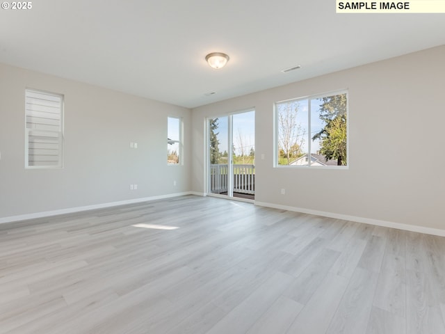 908 NW 178th Way, Ridgefield, WA 98642 - spare room featuring plenty of natural light, light wood finished floors, and baseboards