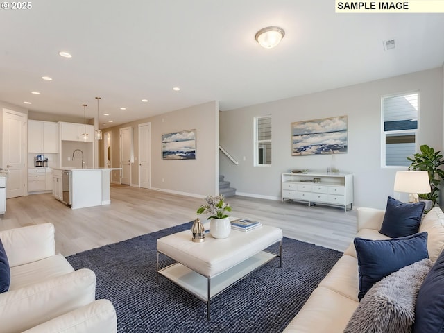 908 NW 178th Way, Ridgefield, WA 98642 - living area featuring light wood-style flooring, stairs, recessed lighting, and baseboards