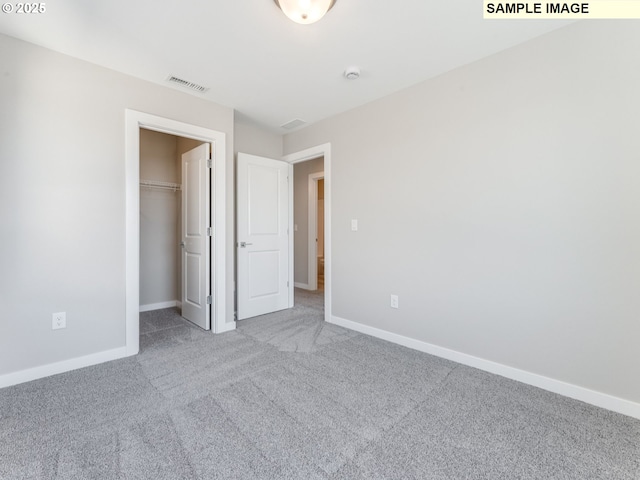 908 NW 178th Way, Ridgefield, WA 98642 - unfurnished bedroom with carpet flooring, baseboards, and a walk in closet
