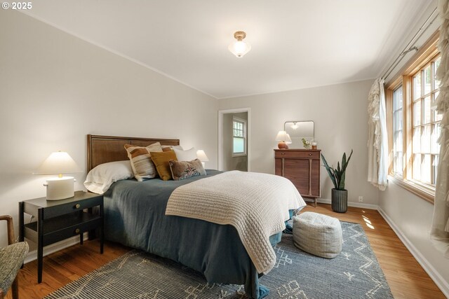 6416 NE 23rd Ave, Portland, OR 97211 - bedroom with multiple windows and wood finished floors