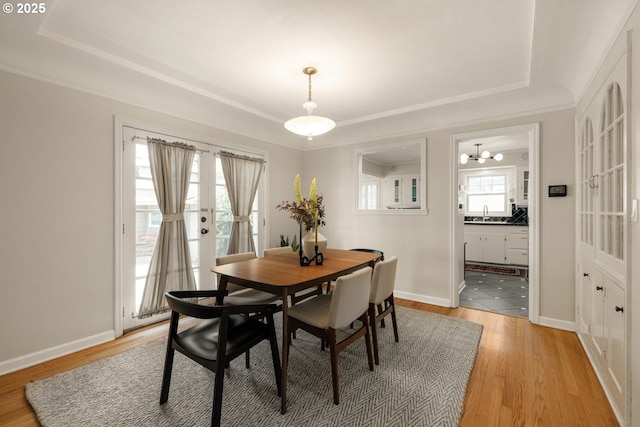 6416 NE 23rd Ave, Portland, OR 97211 - dining space with a tray ceiling, light wood-style floors, a chandelier, and crown molding