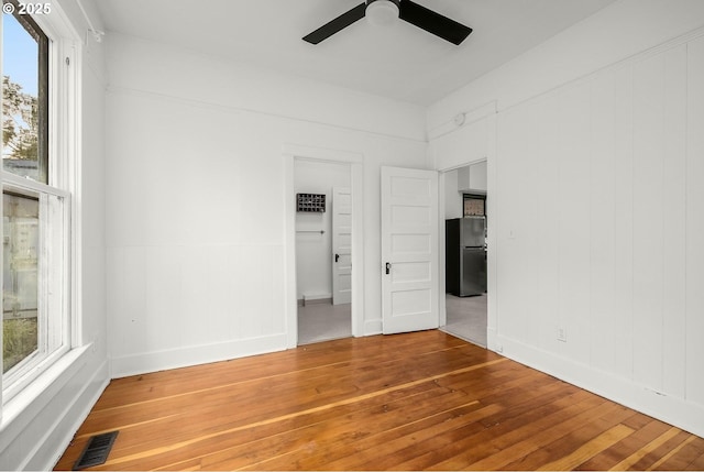 spare room with hardwood / wood-style flooring and ceiling fan