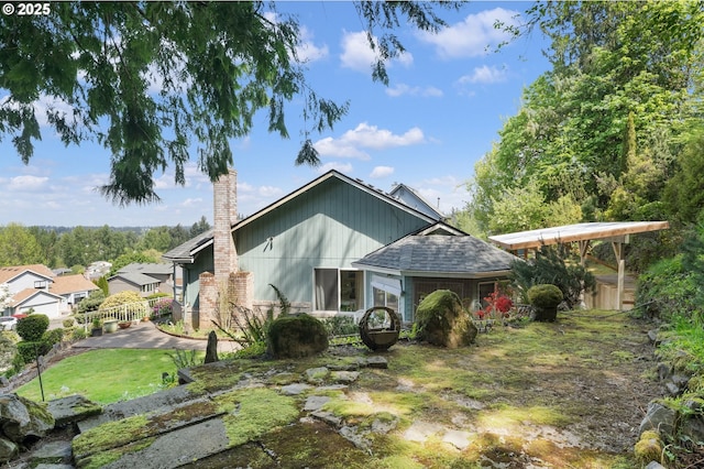 rear view of property with fence and a chimney