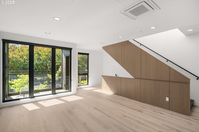 additional living space with light hardwood / wood-style floors