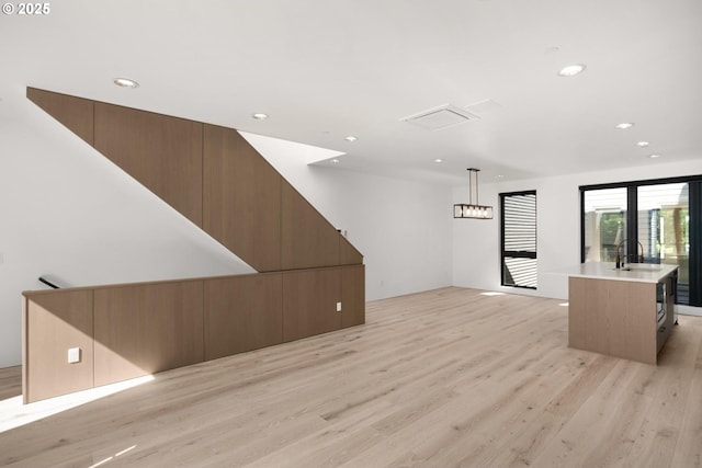 living room with sink and light wood-type flooring