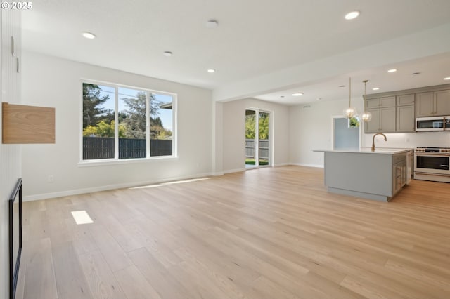 11506 NE 51st Ave, Vancouver, WA 98686 - unfurnished living room featuring recessed lighting, baseboards, and light wood-type flooring