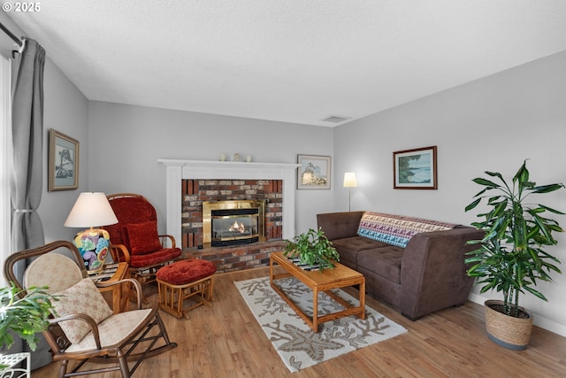 living room featuring a fireplace and light hardwood / wood-style floors