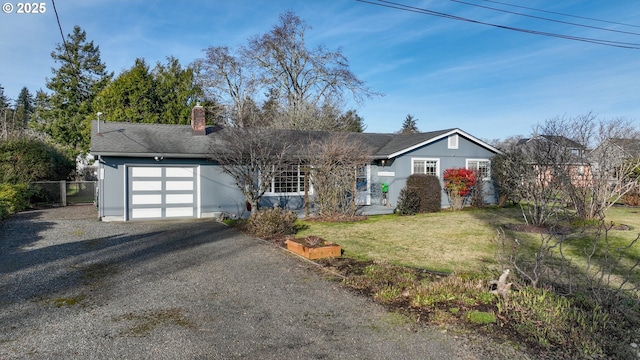 single story home featuring a garage and a front yard