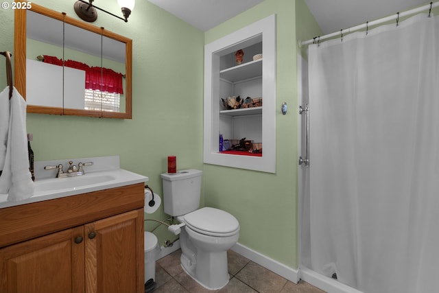 bathroom with vanity, tile patterned floors, toilet, and walk in shower