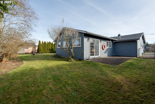 rear view of house with a yard and a patio