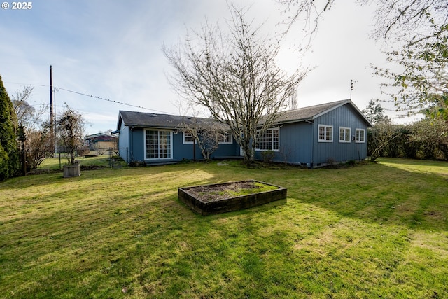 rear view of property with a yard