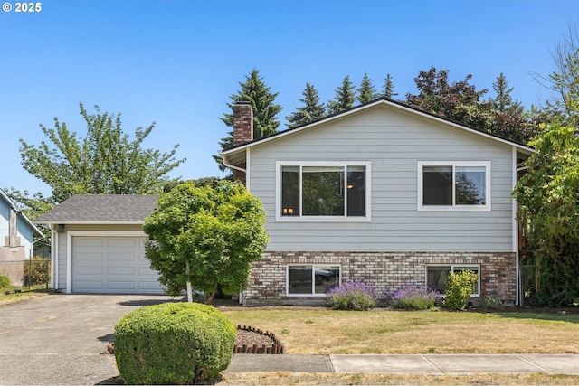 704 SE 207th Ave, Gresham, OR 97030 - view of front facade featuring concrete driveway, a front yard, a chimney, a garage, and brick siding