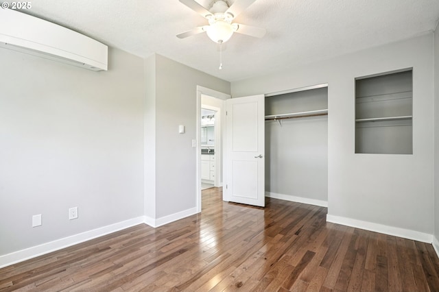 704 SE 207th Ave, Gresham, OR 97030 - unfurnished bedroom with a wall mounted AC, wood finished floors, and a ceiling fan
