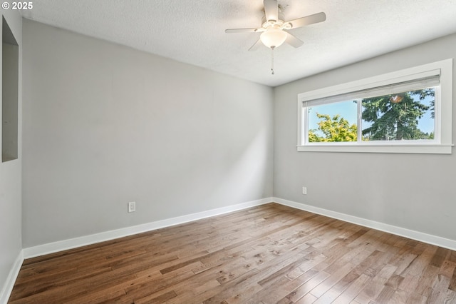 704 SE 207th Ave, Gresham, OR 97030 - spare room featuring wood finished floors, ceiling fan, and a textured ceiling