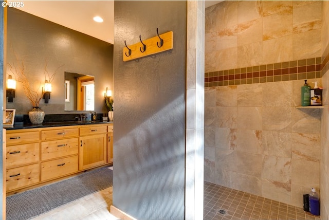 bathroom featuring vanity and a tile shower