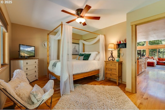 bedroom with light hardwood / wood-style flooring and ceiling fan