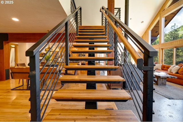 staircase featuring a towering ceiling