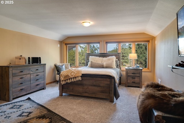 bedroom featuring light colored carpet and vaulted ceiling