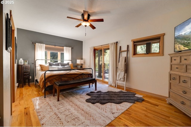 bedroom featuring ceiling fan, access to exterior, and light hardwood / wood-style floors