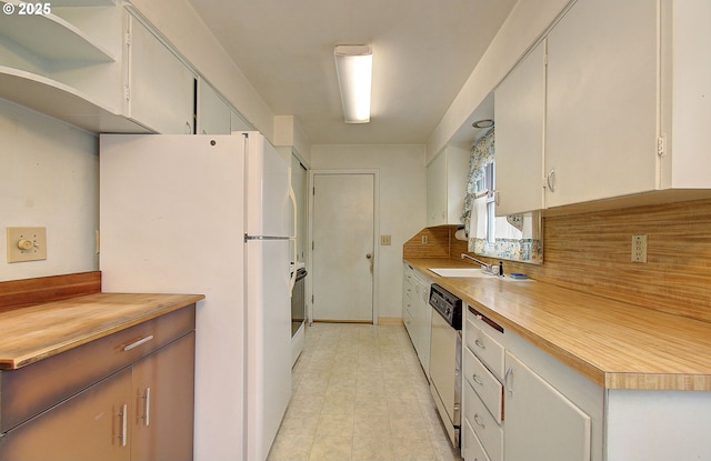 kitchen with open shelves, light countertops, freestanding refrigerator, white cabinetry, and dishwashing machine