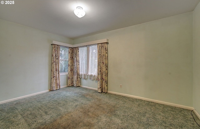 carpeted empty room with baseboards