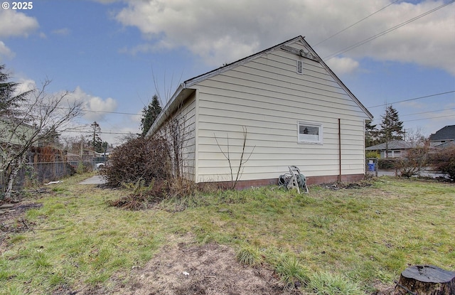 view of home's exterior featuring a yard and fence