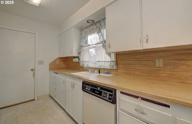 kitchen featuring a sink, white cabinets, dishwasher, and light countertops