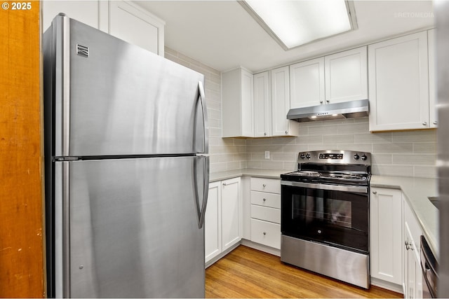 kitchen featuring stainless steel appliances, under cabinet range hood, light countertops, and white cabinets