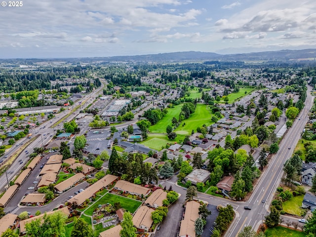 view of property location with a major roadway, mountains, and nearby suburban area