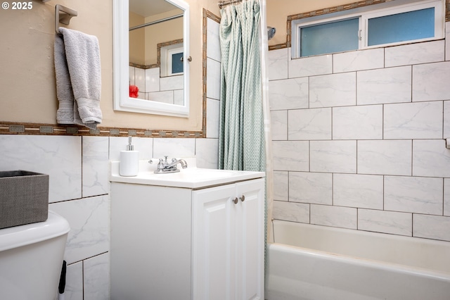 full bathroom featuring tile walls, vanity, toilet, and shower / bathtub combination with curtain