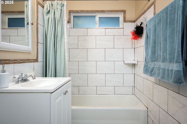 bathroom with decorative backsplash, vanity, shower / tub combo with curtain, and tile walls