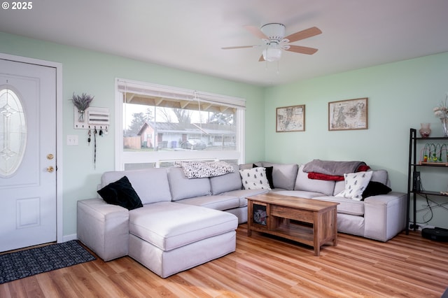 living room with ceiling fan, light hardwood / wood-style flooring, and a healthy amount of sunlight