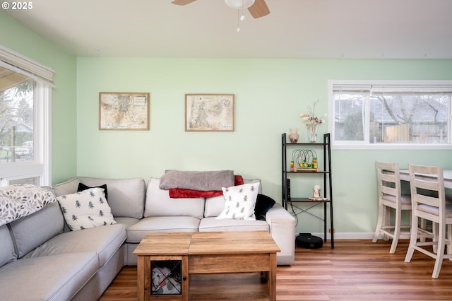 living room featuring hardwood / wood-style flooring and ceiling fan