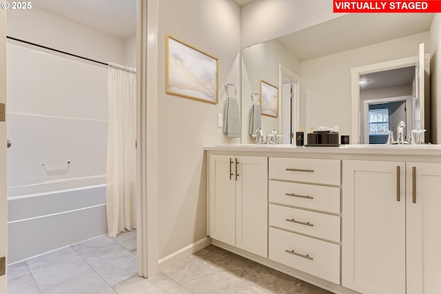 bathroom featuring double vanity, shower / tub combo, baseboards, and a sink