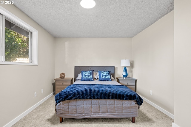 carpeted bedroom featuring a textured ceiling