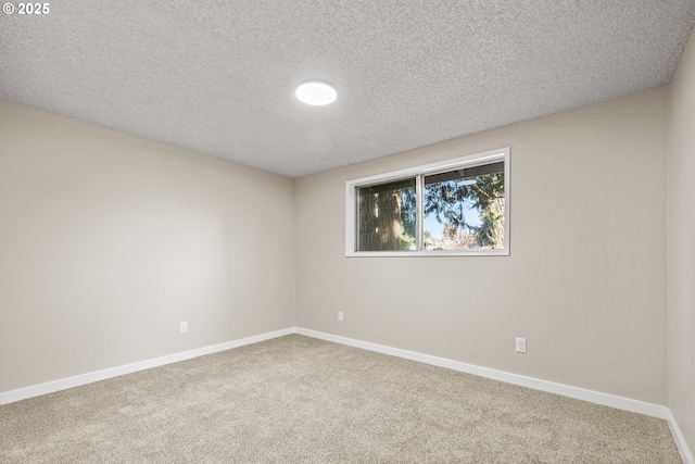 unfurnished room featuring a textured ceiling and carpet flooring