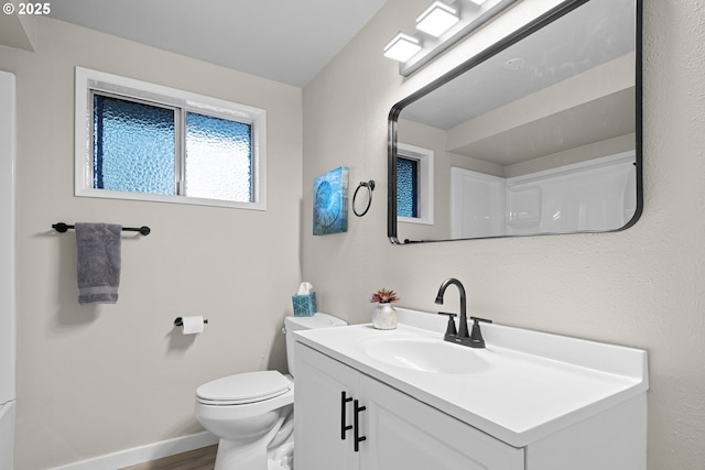 bathroom featuring vanity, wood-type flooring, and toilet