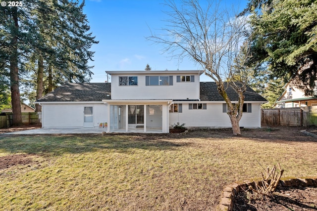 back of property with a lawn and a patio