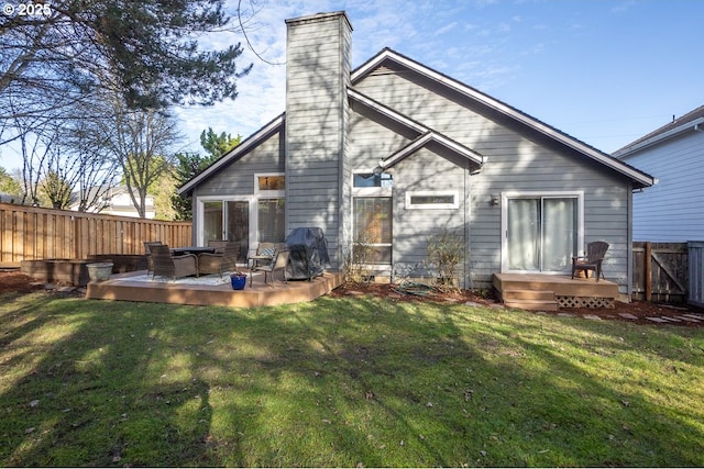 back of property with a lawn and a deck